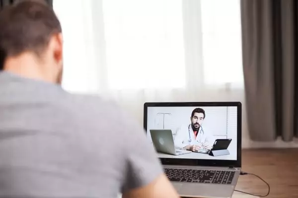 man-having-video-conference-with-his-doctor-during-self-isolation