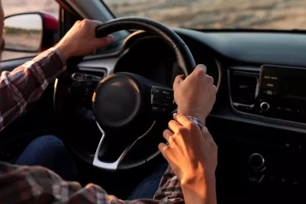 woman-holding-her-boyfriends-hand-while-driving