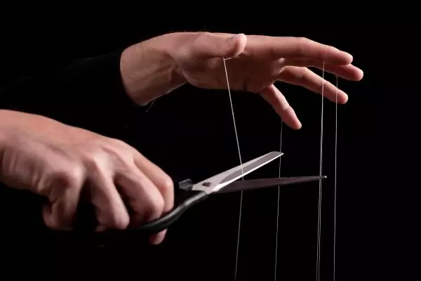 overcoming-addiction-man-cutting-strings-fingers-with-scissors-freedom